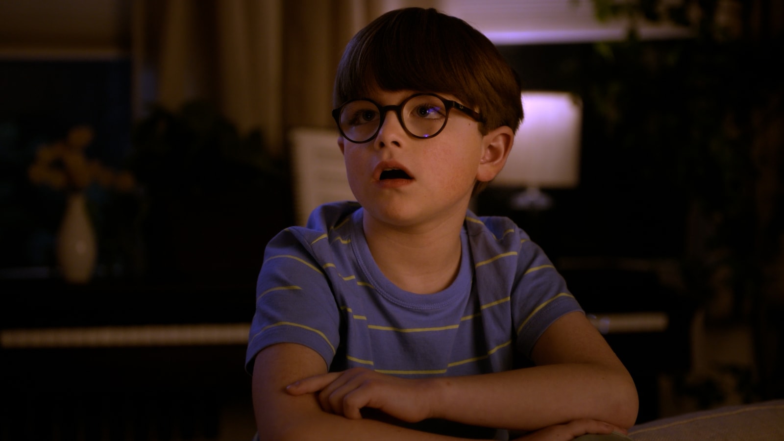 A boy wearing glasses looks up in surprise in the Hershey’s Heroes spot.