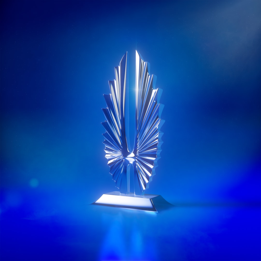 A silver GLAAD statuette centered against a luminous blue background.