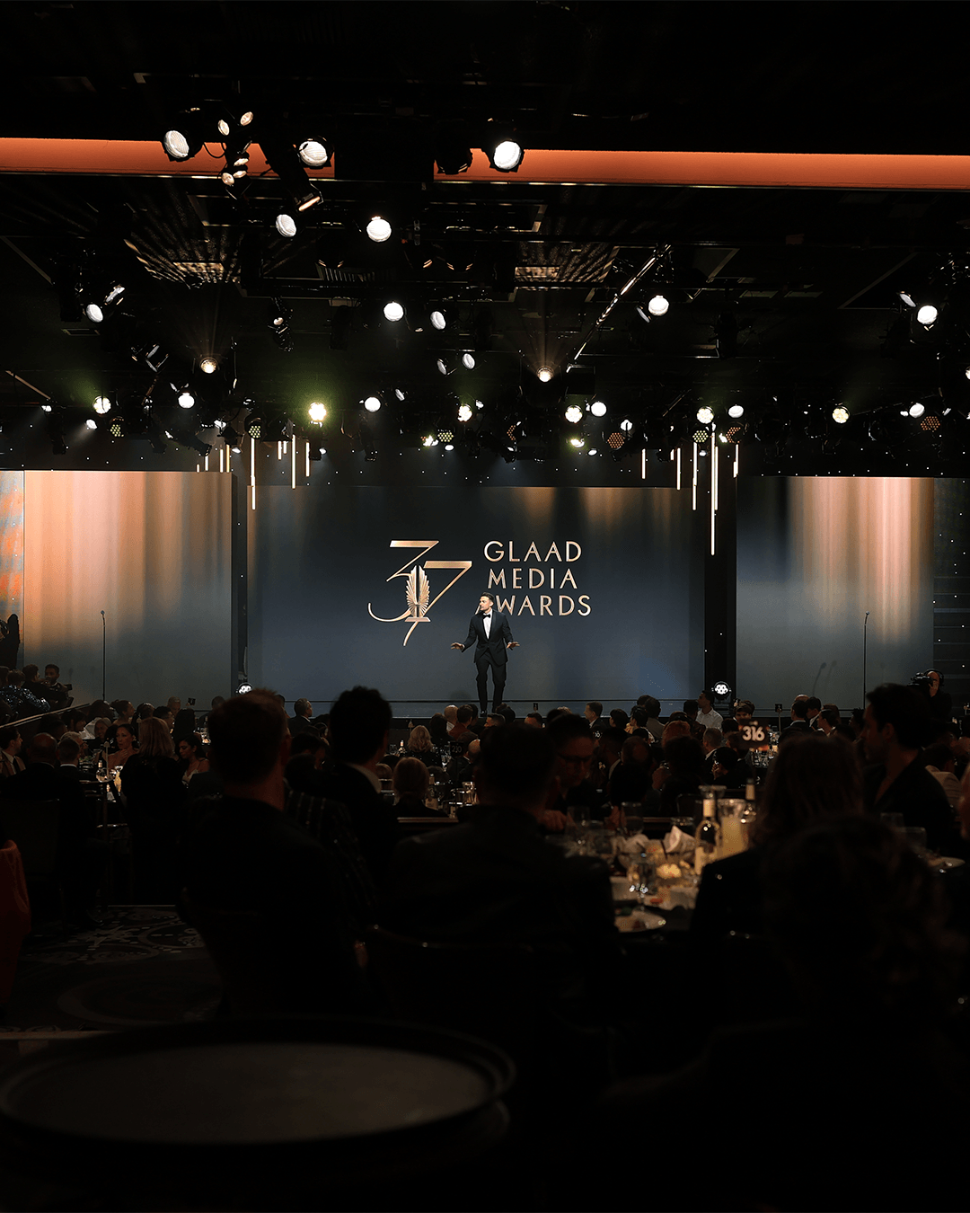 A wide portrait view of the 2026 GLAAD stage and audience.