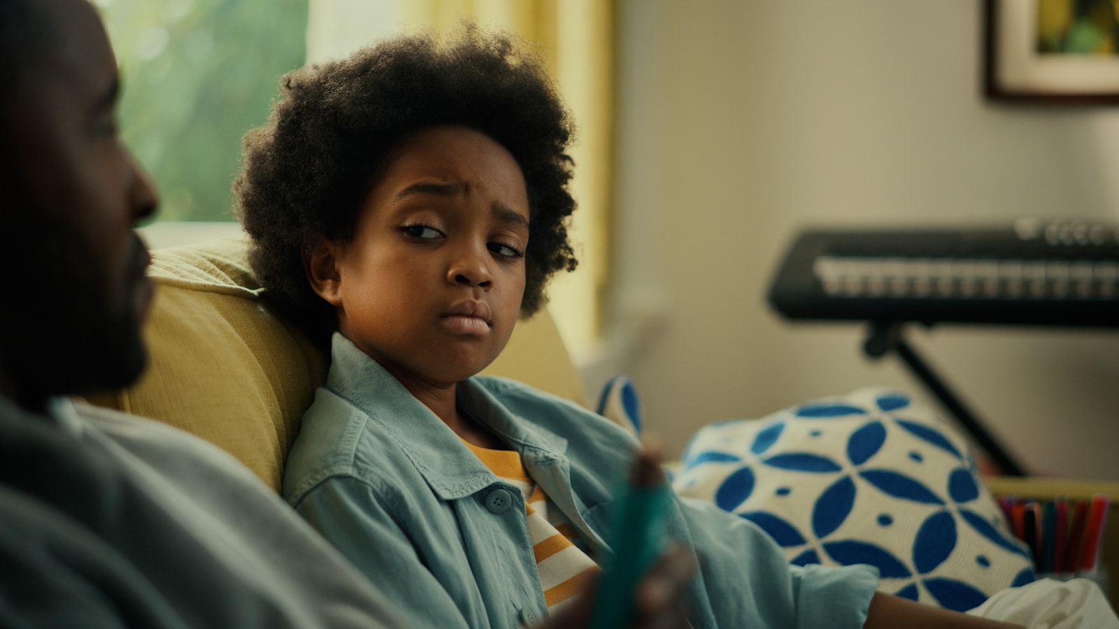 A child sits on a couch looking toward an adult in a Fulfil spot.