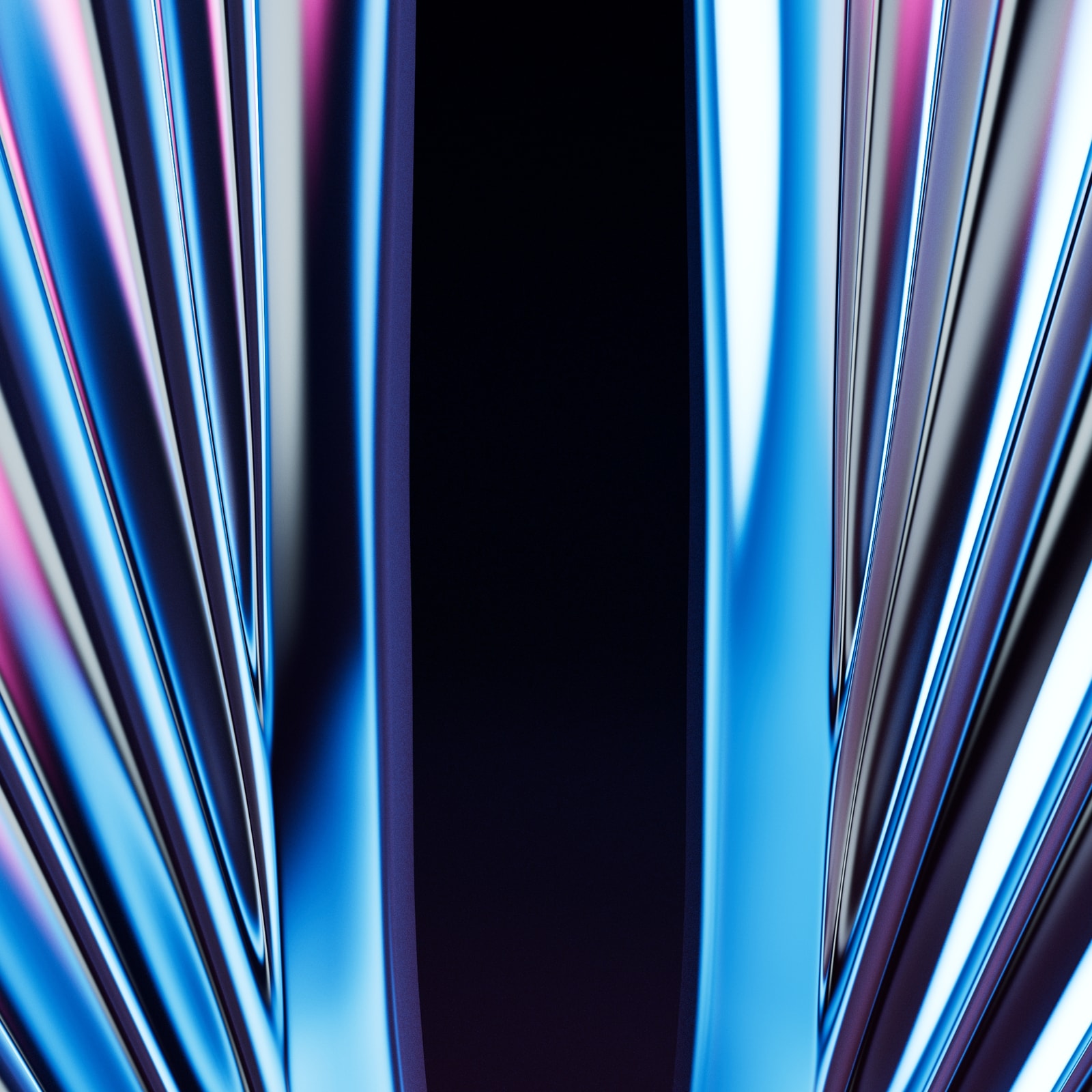 Reflective chrome blades of the GLAAD statuette against a dark background.