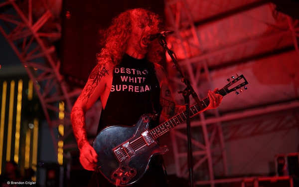 A guitarist performs in red light at Psycho Las Vegas.