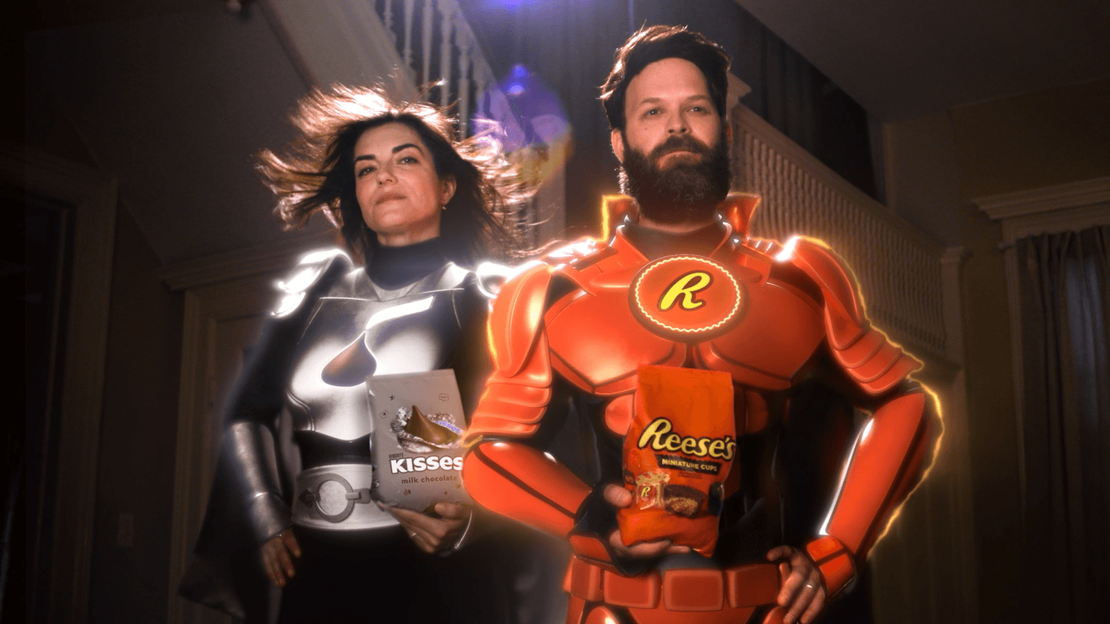 Two costumed candy superheroes stand together in a cinematic scene.