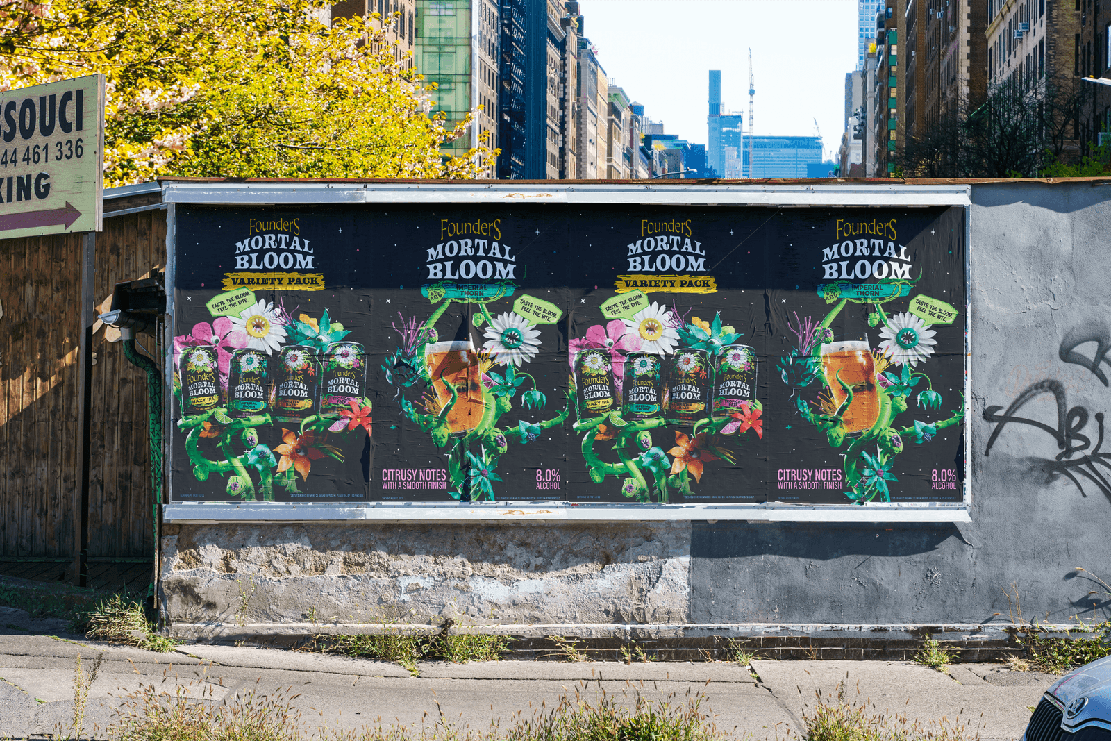 Mortal Bloom poster mockups line a city wall.